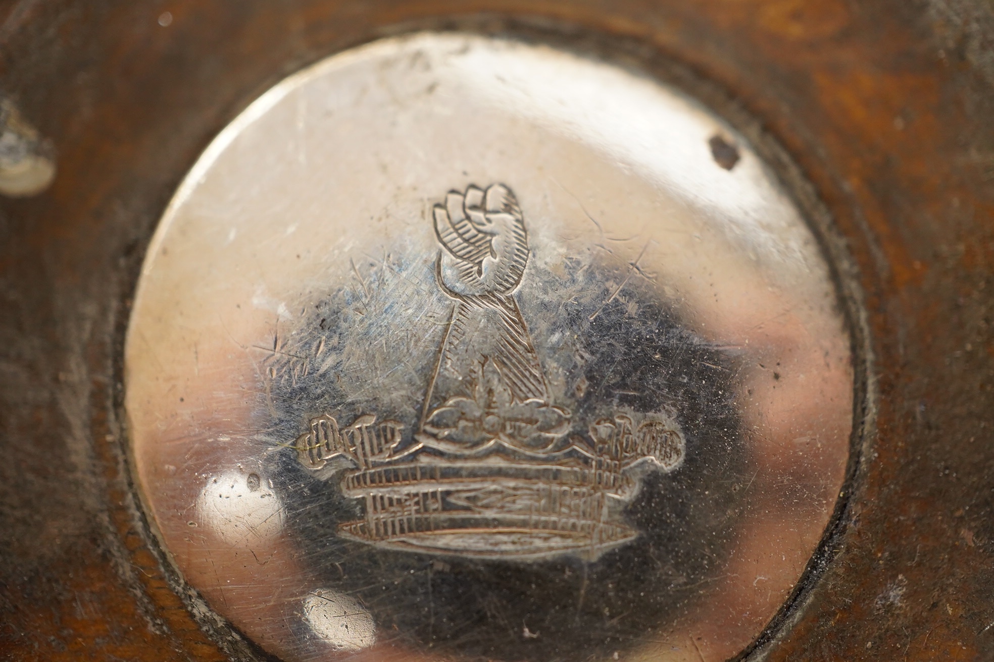 A pair of George III silver wine coasters, by Thomas & John Settle, with gadrooned borders and turned wooden bases, Sheffield, 1821, diameter 15.7cm. Condition - poor to fair